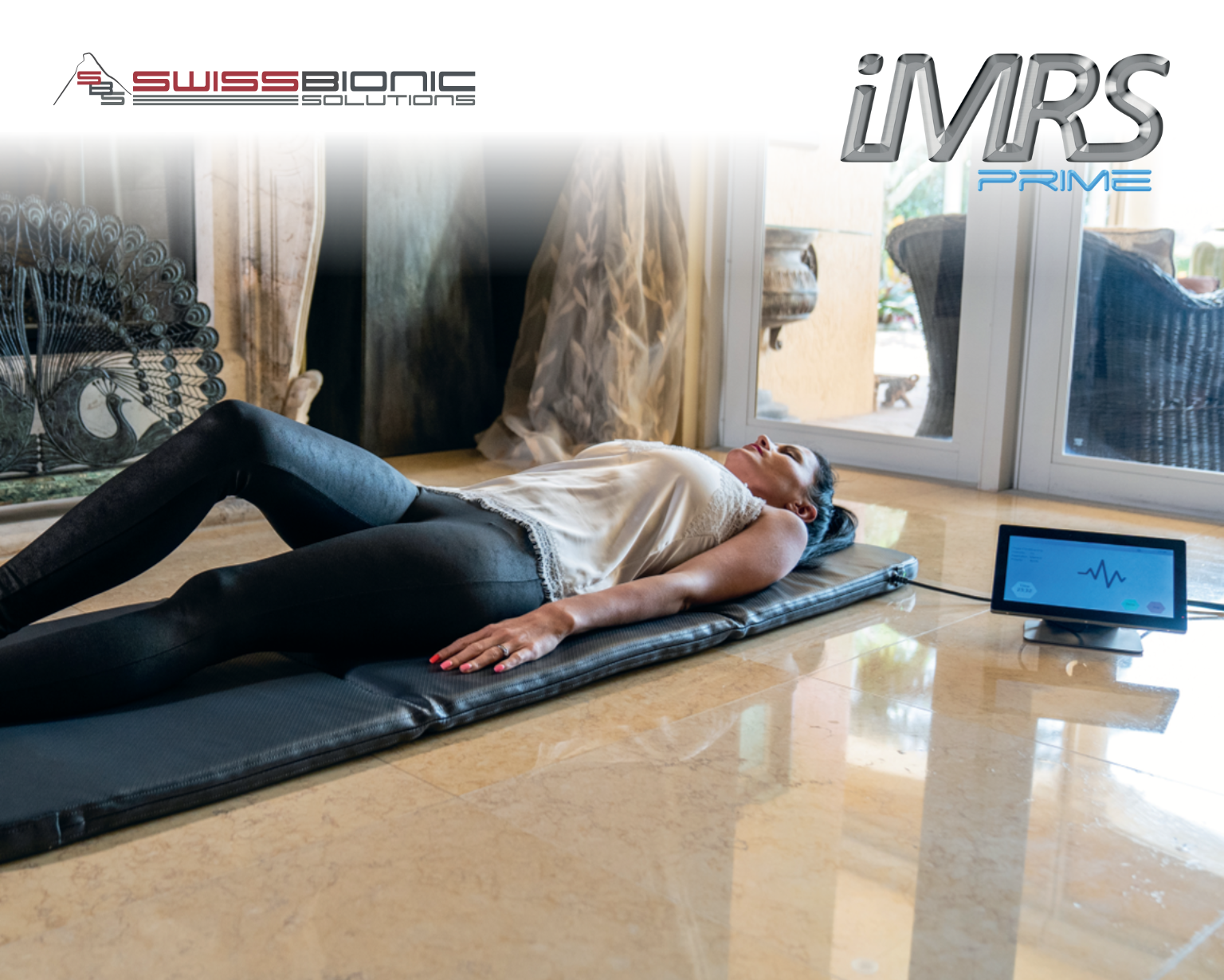 Person relaxing on iMRS Prime PEMF mat during low intensity resonant PEMF session at home